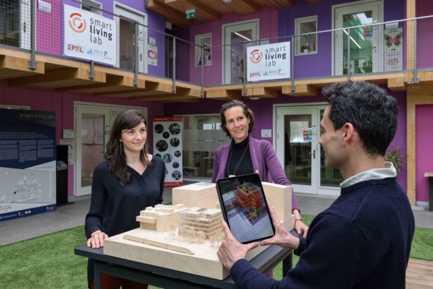 Luisa Pastore, Marilyne Andersen and Sergi Aguacil Moreno with the model of the Smart Living Lab building in Fribourg